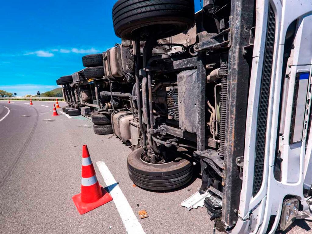 18-wheeler overturns, hazmat spill shuts down eastbound ramp to I-69